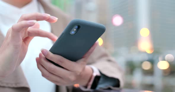 Woman use of smart phone in city