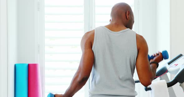 Man exercising with dumbbells 4k