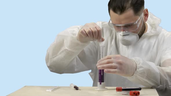 Scientist Stirring Purple Water in a Test Tube