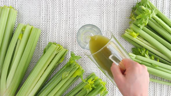 Healthy Eating Concept, Hand Pouring Celery Juice In A Glass