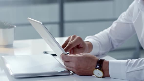 Hands of Businessman Using Tablet