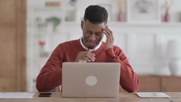 African Man having Headache while Working on Laptop