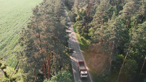 Car overtaking cyclist, aerial drone view