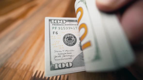 Flipping 100 dollar bills close-up to the camera