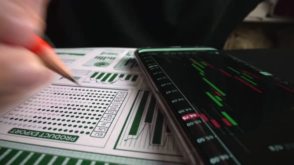 Accountant Analyzing Business Marketing Data on Paper Dashboard at Office Table