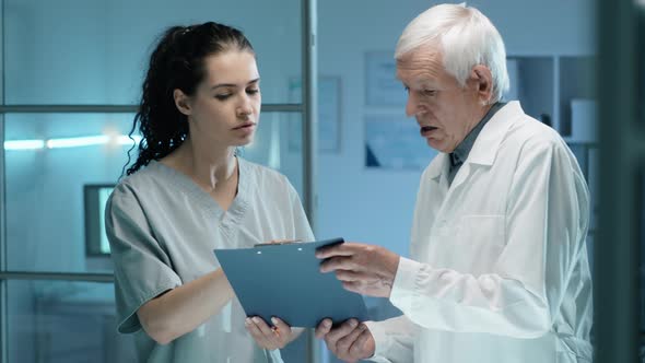 Young Woman Talking with Senior Lab Scientist