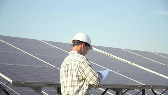 Engineer Checks Solar Panels Productivity