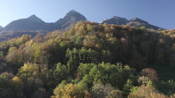 Aerial View Raising Up Over Beautiful Natural Sunny Mountain Landscape Village Resort Landmark