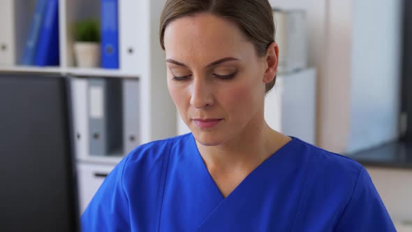 Doctor or Nurse with Computer Working at Hospital