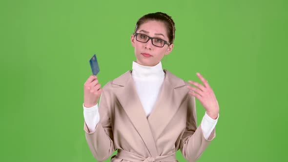 Business Lady Holding a Credit Card in Her Hands Has No Money. Green Screen. Slow Motion