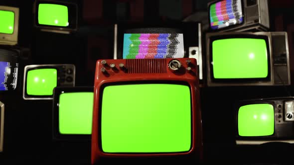 Pile of Retro Televisions turning on Green Screens with Color Bars.