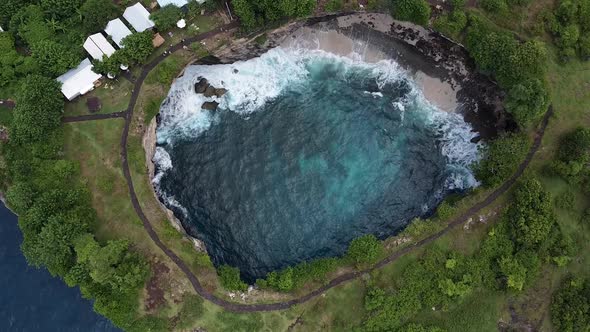 Aerial Birds Eye View Over Broken Beach With Waves Crashing On Shoreline. Establishing Shot