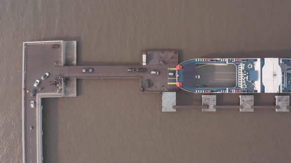 Top down drone shot of cars loading on to a car ferry