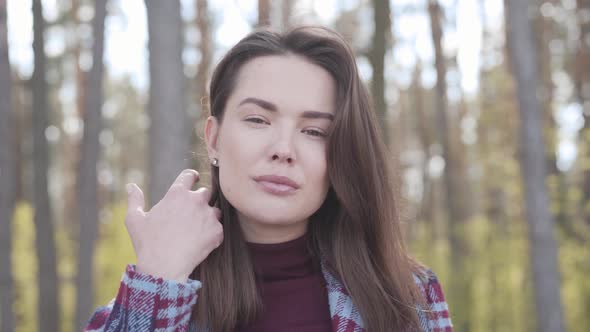 Camera Approaching To Charming Face of Gorgeous Brunette Caucasian Woman Posing in Forest. Young