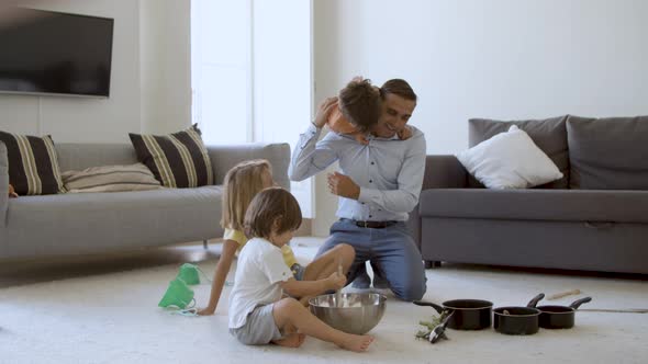 Funny Dad and Three Kids Playing Cooking