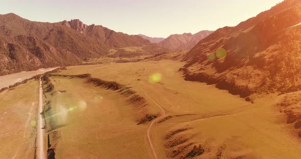 Aerial Rural Mountain Road and Meadow at Sunny Summer Morning