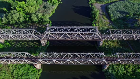 Train Bridge Crossing a River on a Bright Day