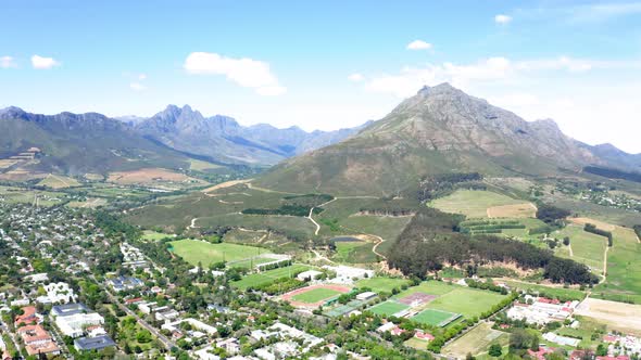 Aerial of Coetzenburg, Danie Craven athletic stadium, surrounding Hottentots-Holland mountains, Jonk