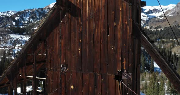 Abandoned antique mining structure in Colorado mountains with drone shoting up.