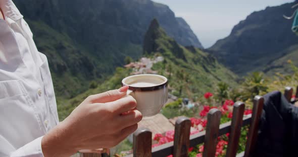 Young Woman Drinks Coffee with Masca Gorge in Background