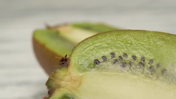 Ripe sliced kiwi on a wooden surface close-up. 