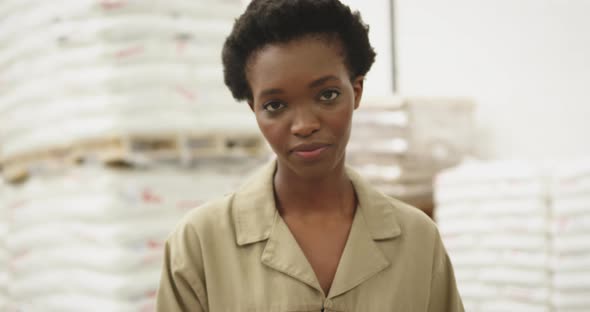 Portrait of young woman working in a warehouse strore room 4k