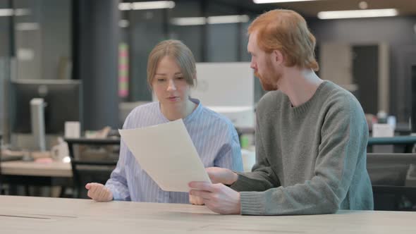 Young Man and Woman Having Loss While Reading Documents