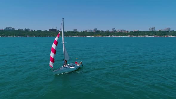 Yacht sailing in open sea. Yachting with sails up at windy day