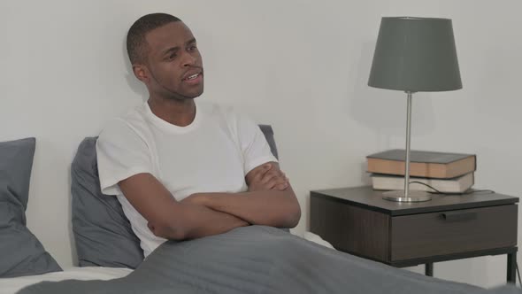 African Woman Thinking While Sitting in Bed