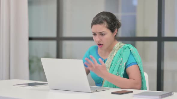 Indian Woman Reacting to Loss While Using Laptop