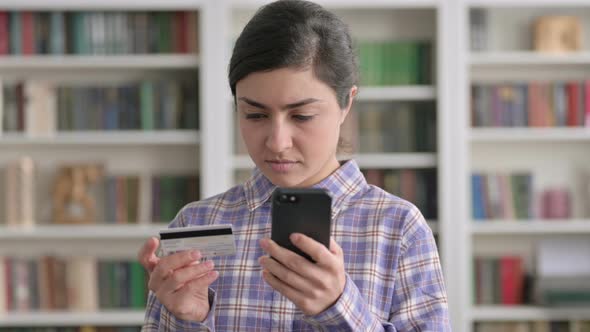 Portrait of Indian Woman making Online Payment on Smartphone,