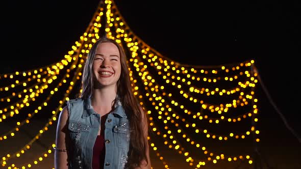 Happy Girl on the Background of Night Party Illumination