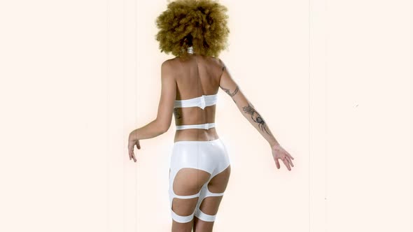 A Female Dancer Moving in White Costume
