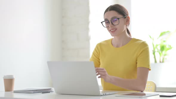 Woman having Wrist Pain while using Laptop in Office