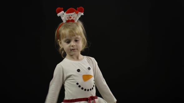 Happy Beautiful Baby Girl in Snowman Costume. Christmas. Make Faces, Dance