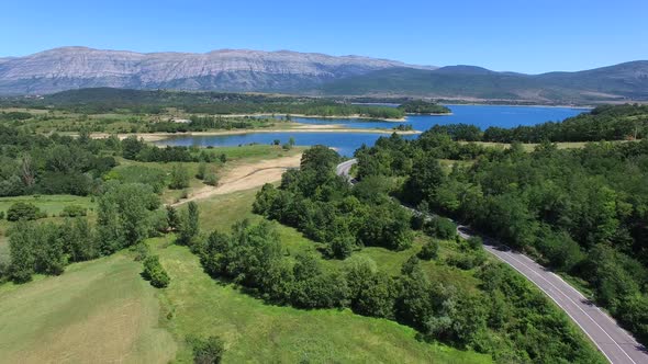 Aerial view of highway through green forested hills, Croatia alt