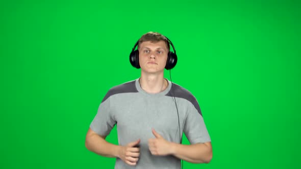 Handsome Guy in Big Headphones Is Running, Chroma Key