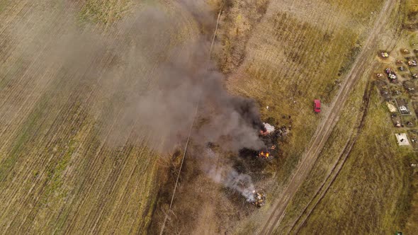 Burning grass on the field in village. 