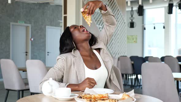 AfricanAmerican Woman Enjoys Delicious Pizza in Cafe