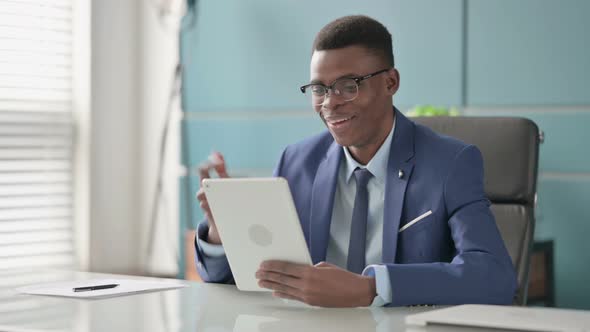 Young African Businessman Making Video Call on Tablet in Office