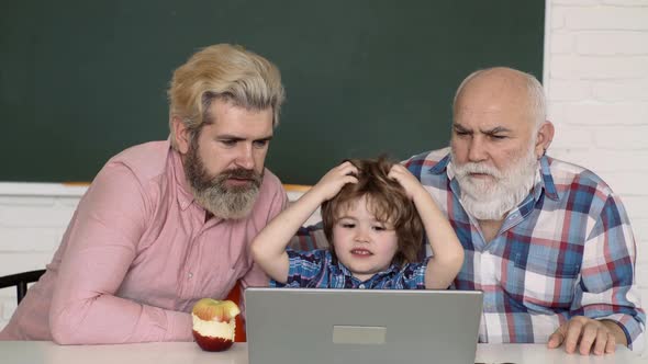 Education Technology. Schoolboy Studying Homework at Home. Father, Grandfather and Child Son