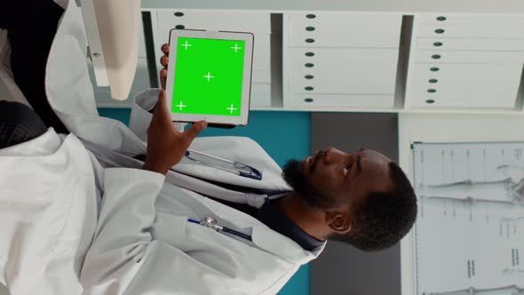 Vertical Video Doctor Holding Digital Tablet with Horizontal Greenscreen