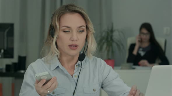 Busy Woman Having Important Conversation Via Laptop in the Office