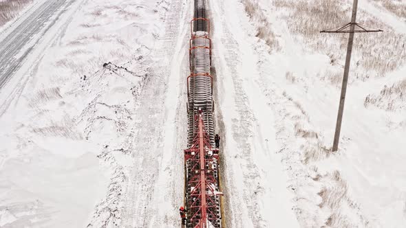 Aerial View UHD Railway Construction Machine Works in Winter. Railway Track Laying Machine. Railway