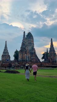 Men and Women with Hat Tourist Visit Ayutthaya Thailand at Wat Chaiwatthanaram During Sunset