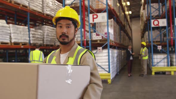 Portrait of young man working in a warehouse smiling 4k