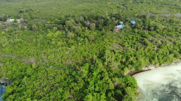 Aerial: Flying over tropical island, travel destination in Wakatobi Indonesia