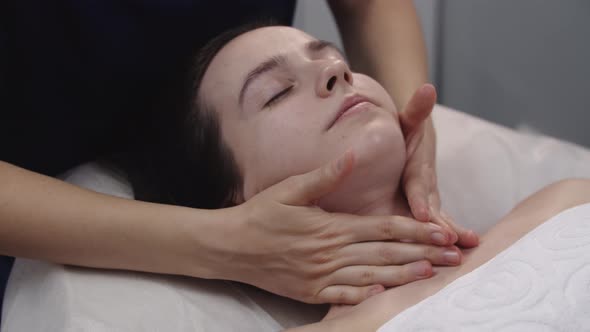 Massagist Doing Massage Using Her Fingers on the Neck of Her Female Client