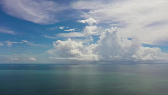 Surface of Blue Ocean with Waves and Blue Sky with Cloud