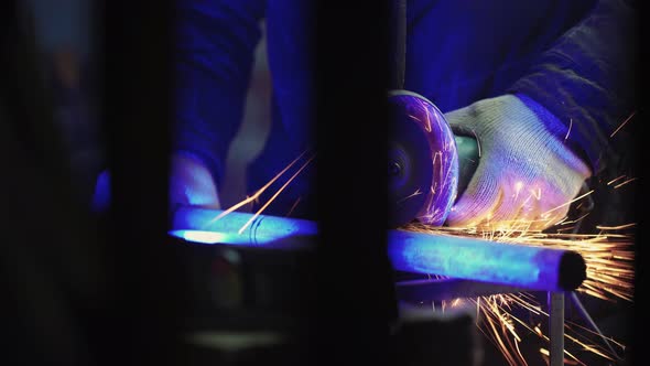 Mechanic Cuts Off Metal Pipe with a Grinder